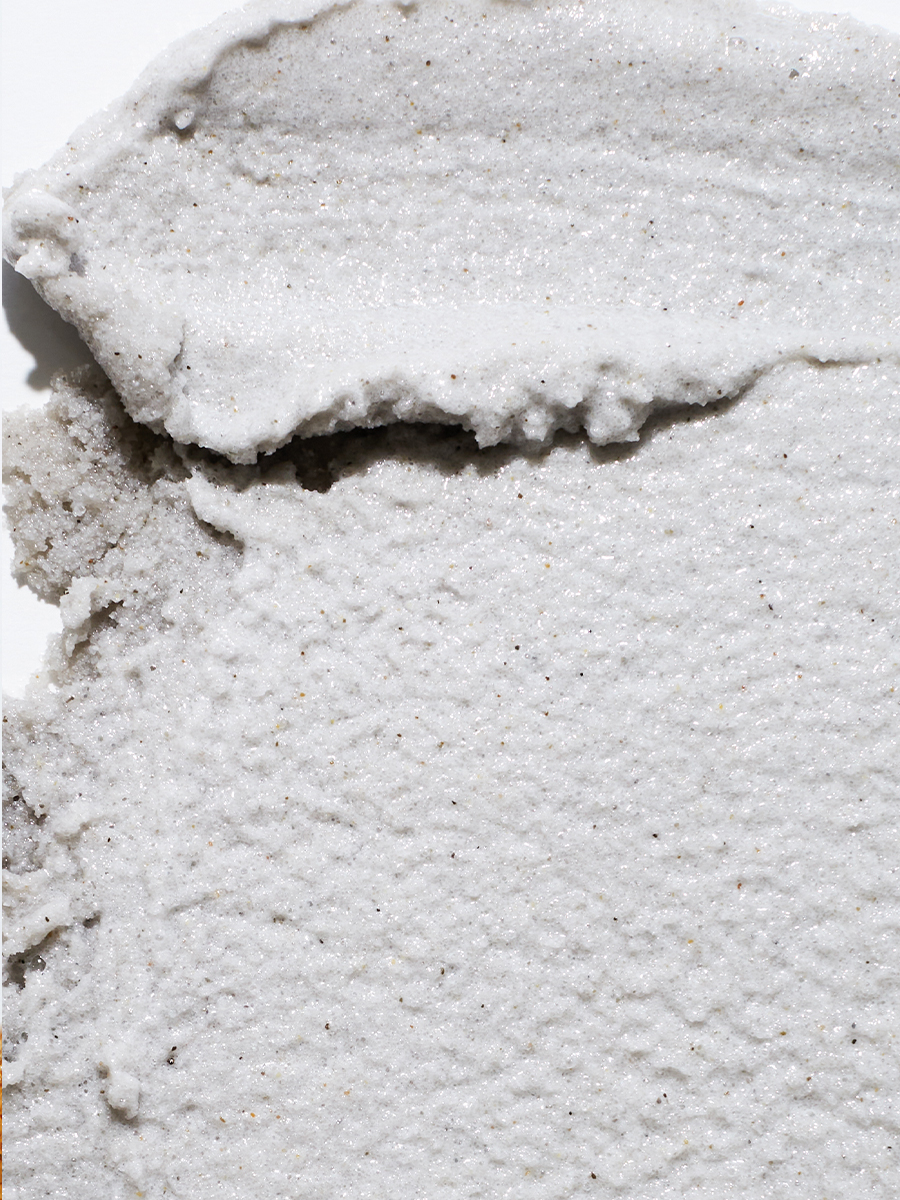 Extreme macro close-up of a gritty white exfoliating scrub texture.